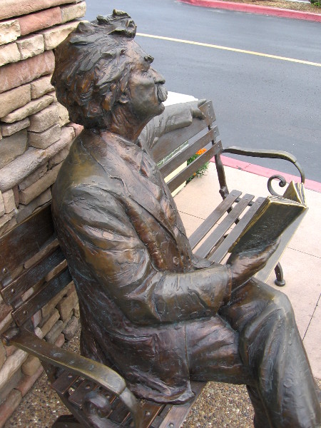 Samuel Clemens gazes up from his book.