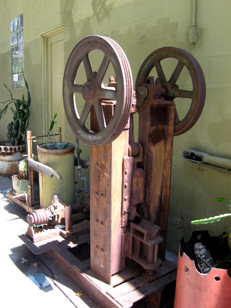 Lots of metal industrial contraptions decorate the outside wall.