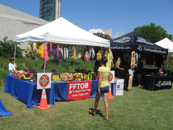 Used firefighter turnout bags and skateboards sold in front of Hilton.