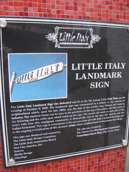 Plaque explains the history of the Little Italy Landmark Sign.