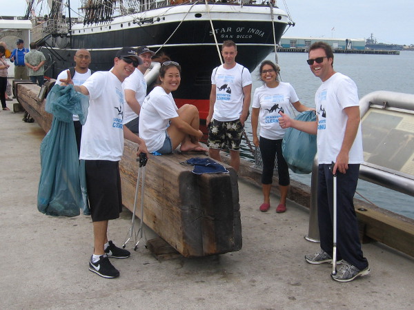 Volunteers help clean up San Diego Bay near the Star of India.
