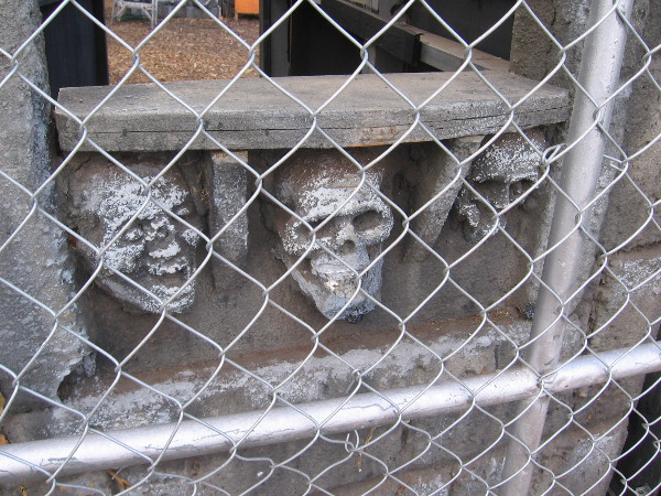 Close look at skulls embedded in the castle-like entrance.