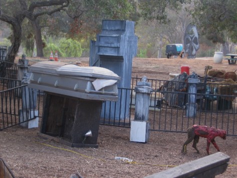 A ravenous, hellish hound prowls the perimeter of a vast cemetery.