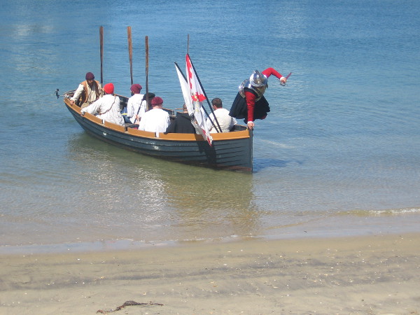 Cabrillo leaps from the galleon's small boat onto the shore!