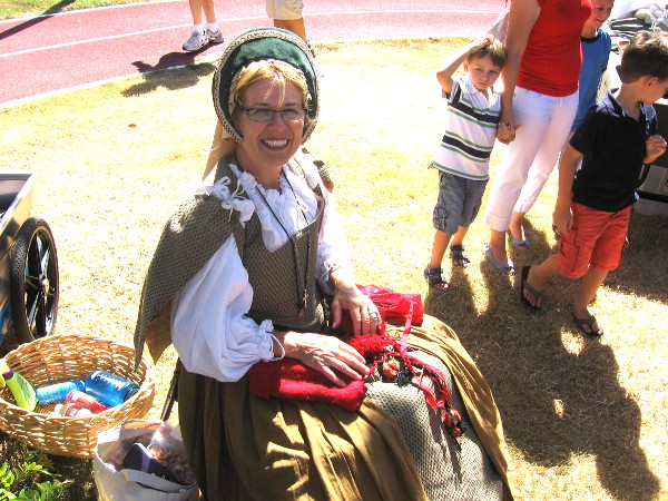 Friendly lady was making woolen caps to be worn under those heavy steel helmets!