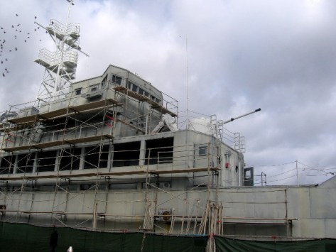 Scaffolding along the side of the weathered old USS Recruit in Point Loma.