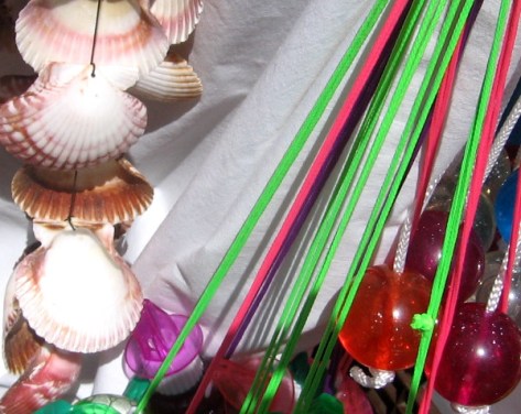 Shells and dangling ornaments for sale on small vendor's cart near the Midway.
