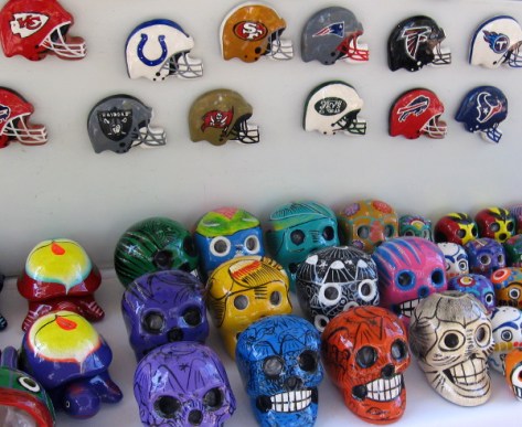 Combination of football helmets and skulls on display for passing tourists.