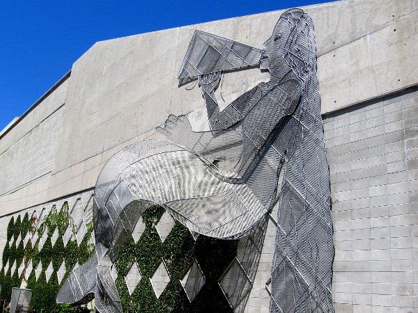 Mermaid with a megaphone on the bay side of the narrow Canyon Path.