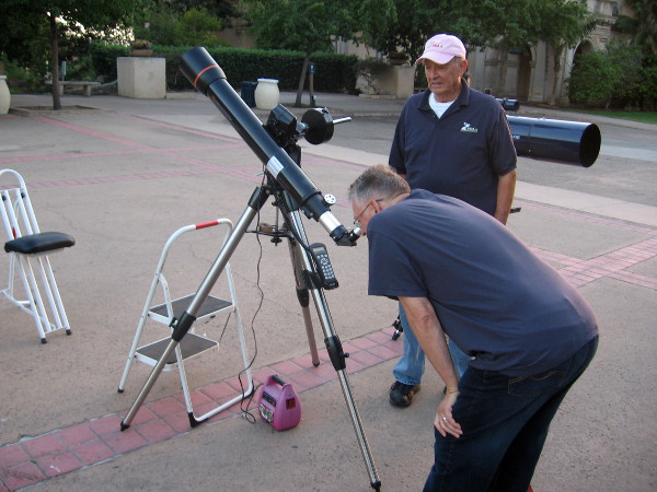 Someone checks out a half moon around sunset.