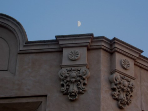 My little camera barely registers the moon above the Reuben H. Fleet Science Center.