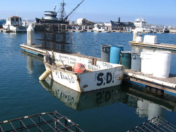 Small boat painted with various names, including Rambo!