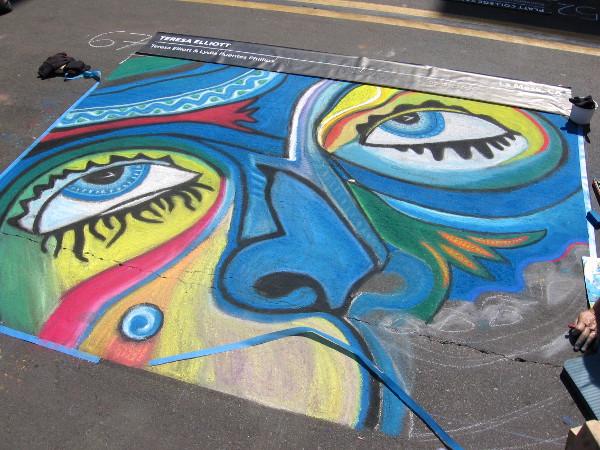 Teresa Elliot is almost finished with this abstract many-colored human face.