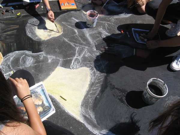 Chalk outlines of human figures that are slowly taking form.