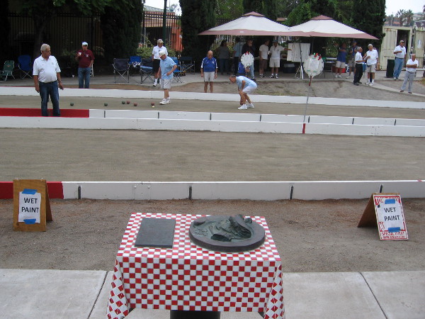 Two bocce courts are open to the public in Amici Park near sculptures of Italian food!