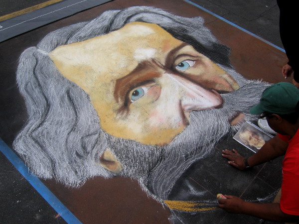 Shawnet Sweets chalk art depicts a colorful, whiskered person.