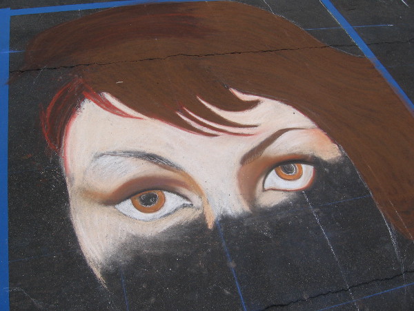 Team Parada chalk art eyes appear on a downtown San Diego street.
