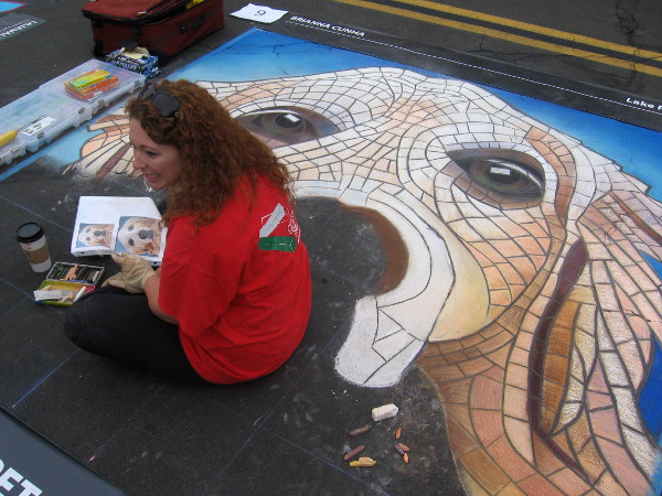 Brianna Cunha chats with a young person about her fun dog chalk art.
