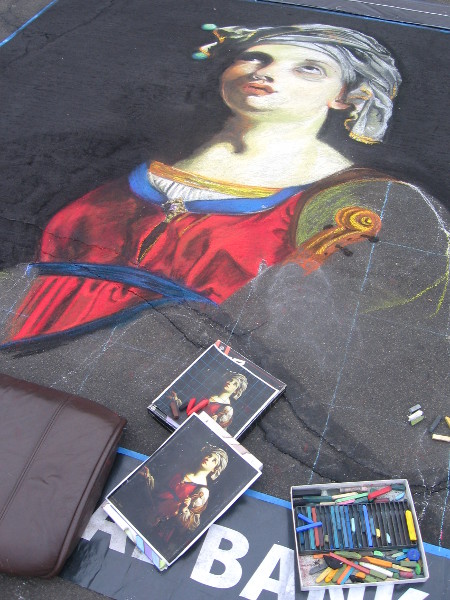 Lauren Minadeo is working on a chalk art portrait.
