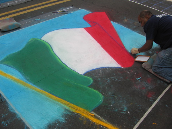 Byron Houston weaves a windblown flag of Italy with a small stick of chalk.