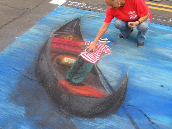 Movingarte is floating a chalk gondola on the dry asphalt canvas.