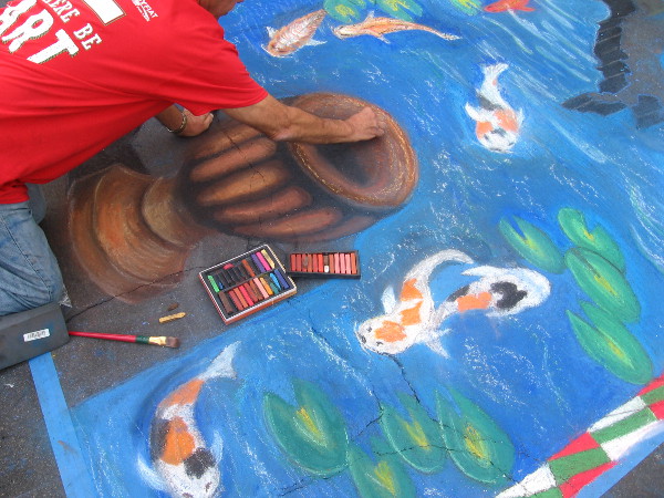 Michael Zamora puts the finishing touches on a chalk urn.