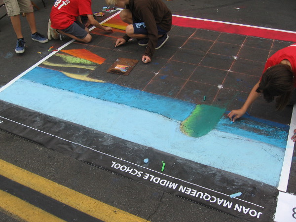 Joan MacQueen Middle School is getting started on their Festa chalk art entry.