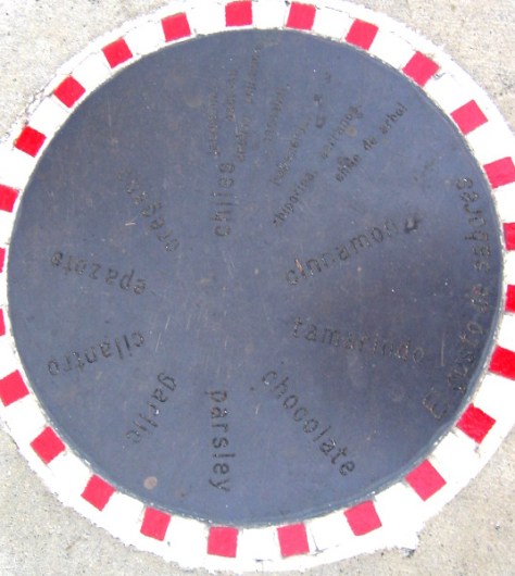 Round plaque at Amici Park shows many popular spices.