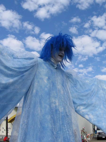 Super tall Boo is blue, and he seems to blend in with the clouds.