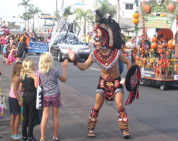 The San Diego State University mascot Aztec Warrior gives a high five!