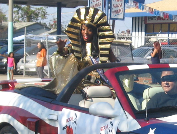 A beauty queen is wearing a big, golden pharaoh headdress!