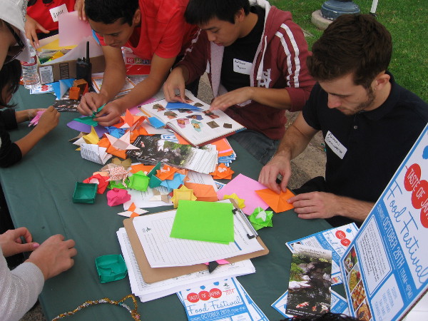 Guys creating origami courtesy of the Japanese Friendship Garden.