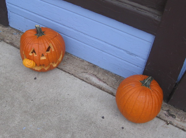 One pumpkin is devouring another in a festive nook in Balboa Park!