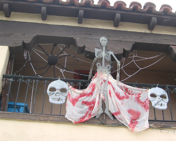A studio in Spanish Village has skulls, spider and a skeleton hanging around.