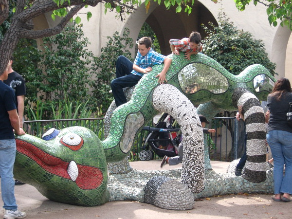 Kids play on crazy creature created by Franco-American artist Niki de Saint Phalle.