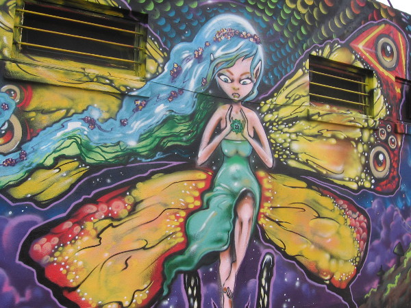 Super cool mural in University Heights has colorful butterfly lady as centerpiece.