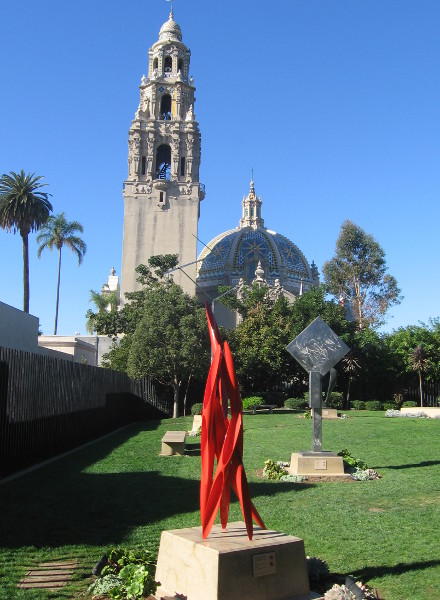 California Tower high in the blue sky behind colorful, unique artwork.