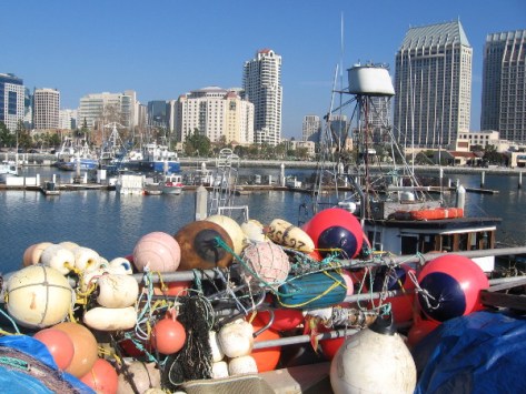 Colorful floats of different sizes tangled over the railing at edge of Tuna Harbor Pier.