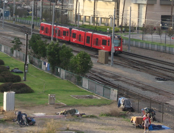 Homeless by trolley tracks between San Diego Convention Center and Petco Park.