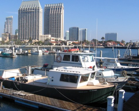 Hyatt, Marriott and Hilton rise behind Tuna Harbor fishing boats.