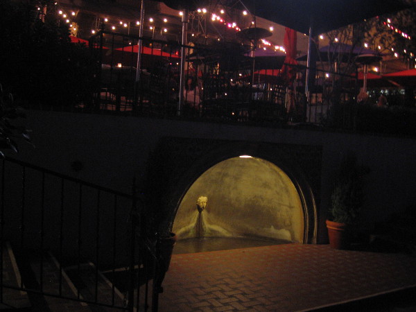 Illuminated fountain beside patio beneath The Prado restaurant in Balboa Park.