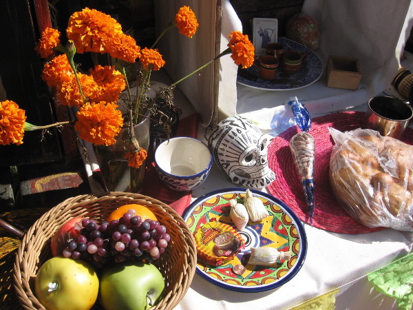 Altars often contain food liked by the deceased, to entice their spirits.