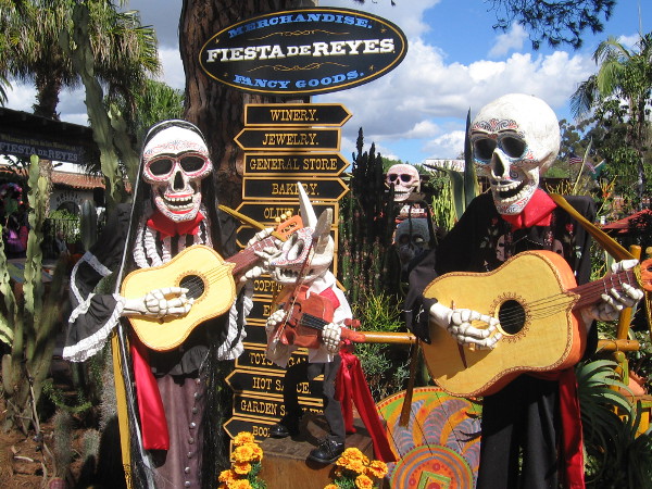Mariachi skeletons strum guitars at entrance to Fiesta de Reyes.