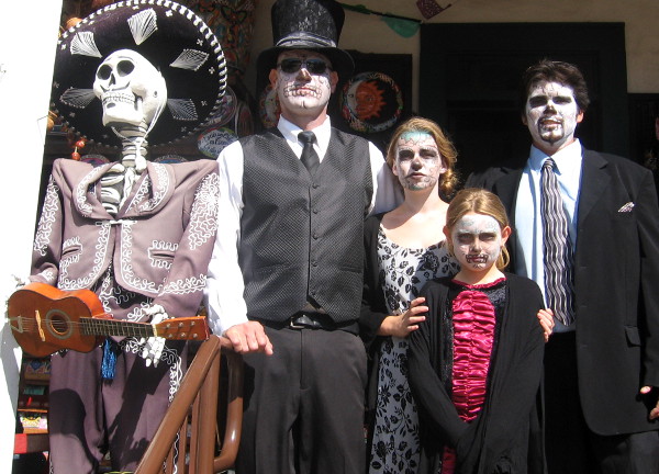 This well-dressed family all had their faces painted to resemble skulls!