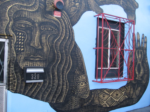 Elaborate figure's arm embraces a building window. Art by Zio Ziegler.