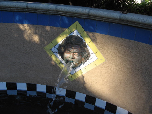 Water splashes from face in fountain at west end of the Craig Noel Garden.