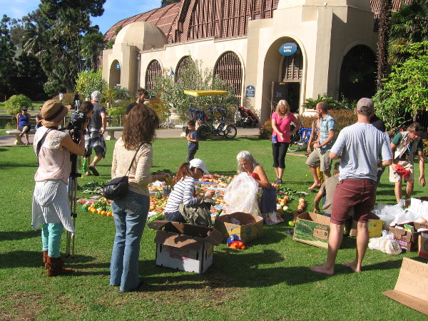 A crowd watches near the Botanical Building as the food creation nears completion.