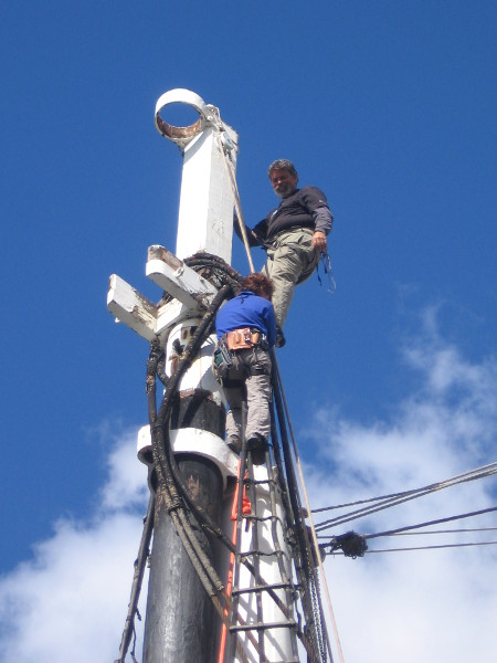 San Diego Maritime Museum volunteers work high up on the historic Star of India.