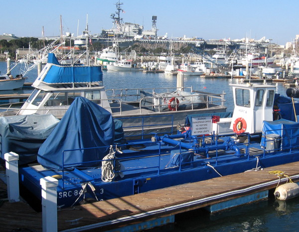 USS Midway aircraft carrier museum can be seen beyond the fleet of fishing vessels.