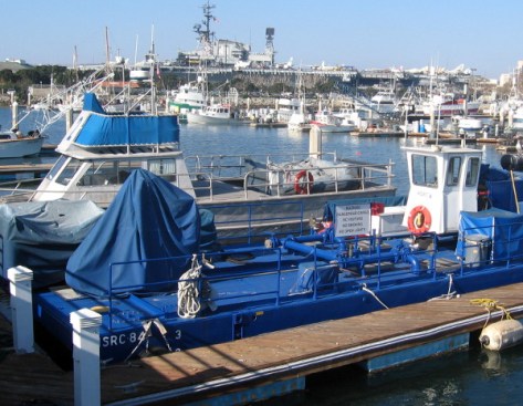 USS Midway aircraft carrier museum can be seen beyond the fleet of fishing vessels.